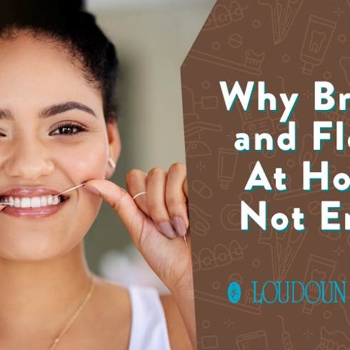 Close-up of a person brushing their teeth. A white toothbrush with light blue bristles cleans white teeth on the side of their mouth.