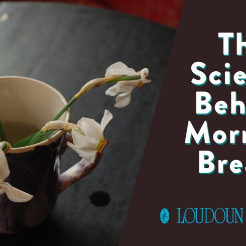 A man sleeps on his back with his mouth slightly open. He rests on white bedding under a cool light.