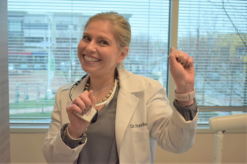 Dr. Maya holding floss